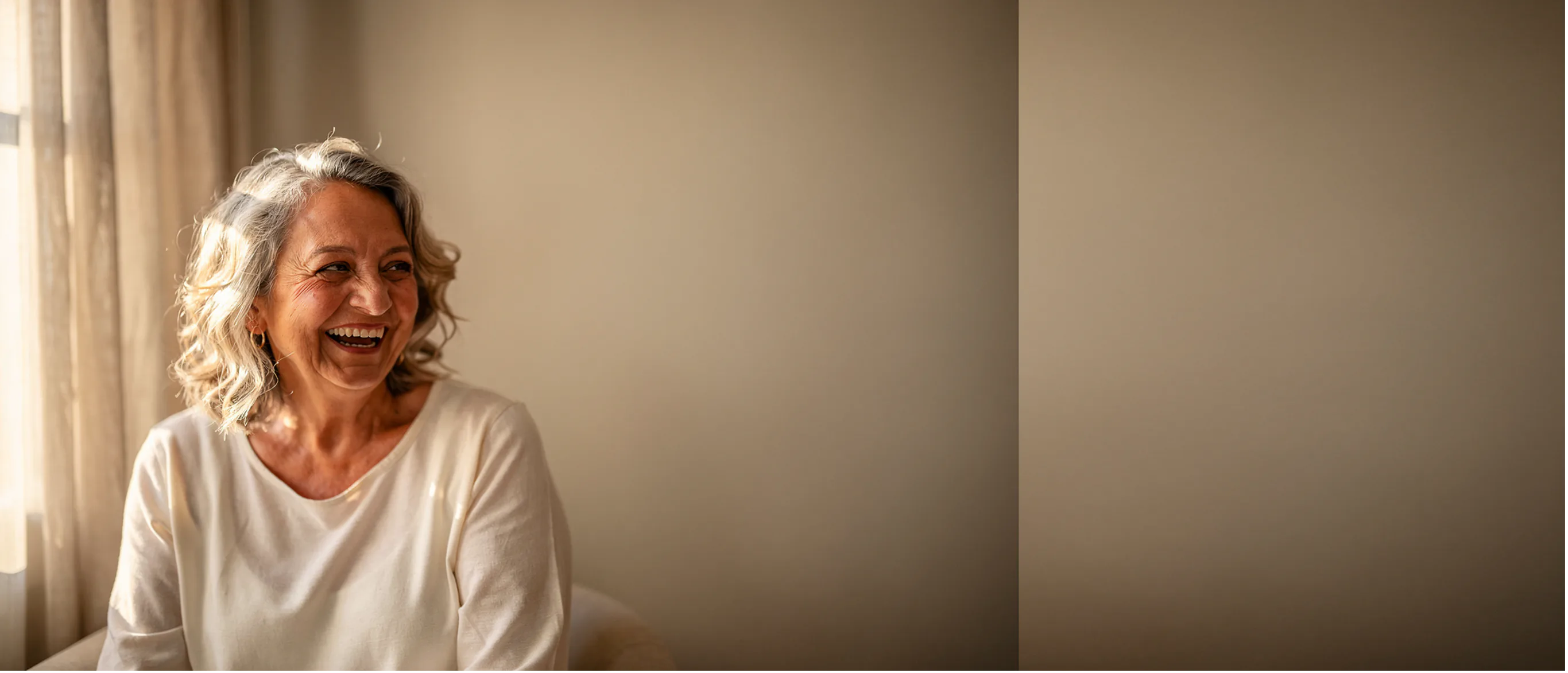 A patient smiling in warm natural light at home