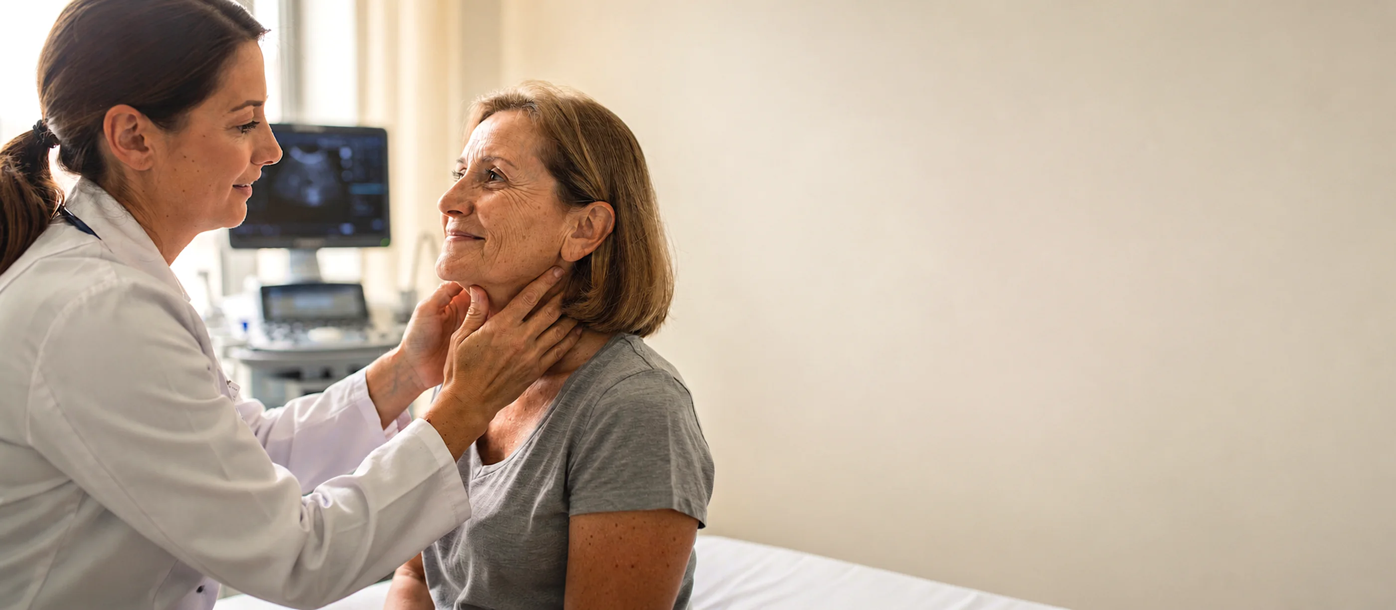 Doctor gently examining a patient's neck during a thyroid consultation